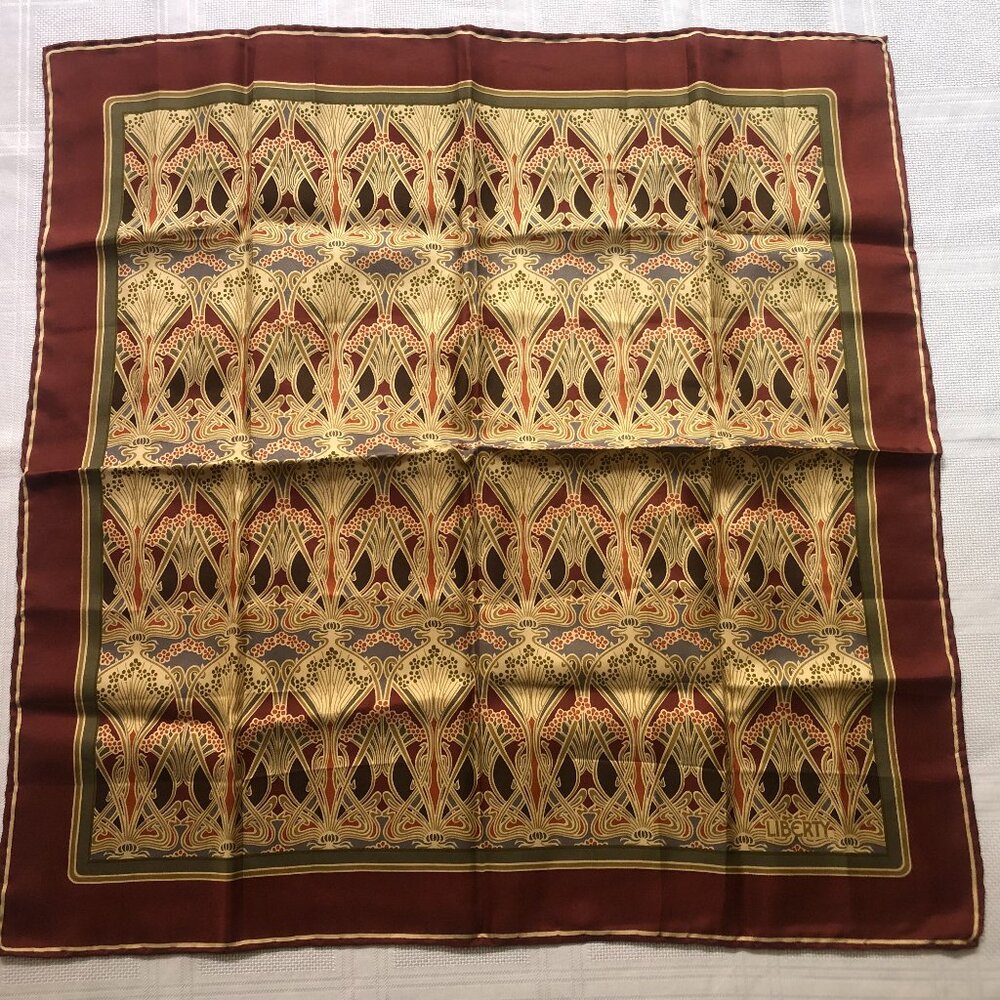Like new Liberty of London silk scarf is burgundy-marron and gold tone colors